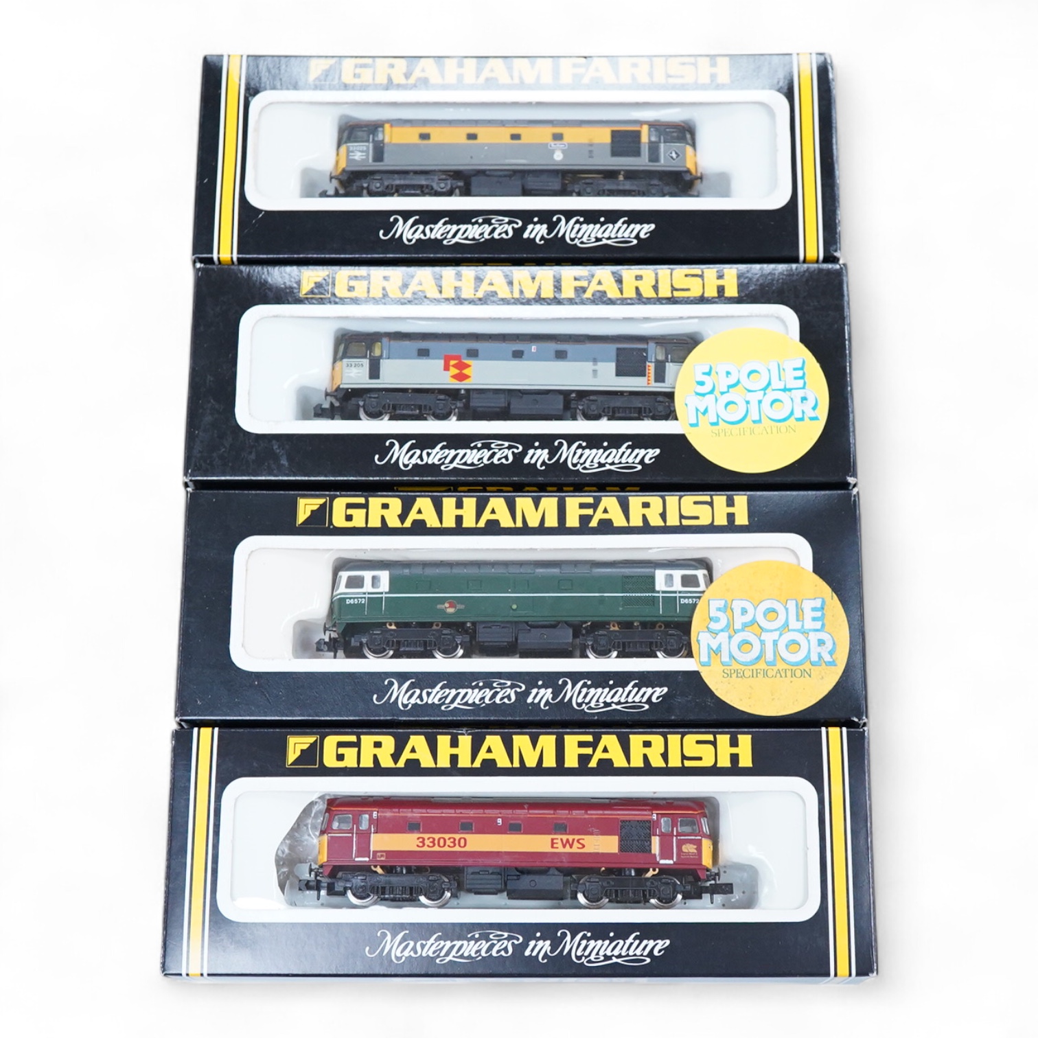 Four boxed Graham Farish N gauge railway Class 33 diesel locomotives; a BR, D6572 (8314), a BR Distribution Sector, 33 205 (8317), an EWS, 33030 (831A) and a BR, 33025 (8312).